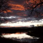 lake with red clouds reflected in water