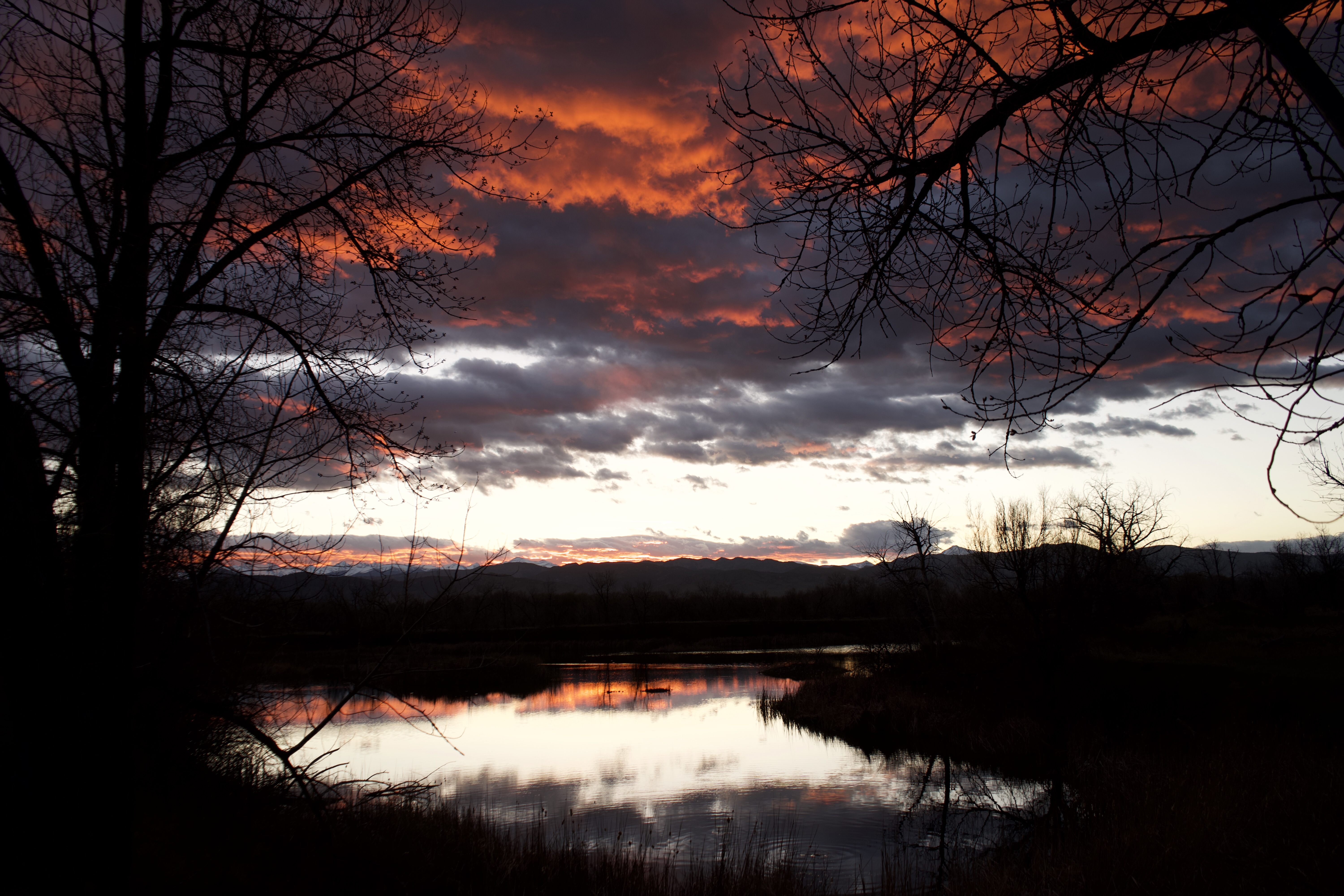 lake with red clouds reflected in water